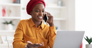 A woman with laptop and phone exploring teams telephony