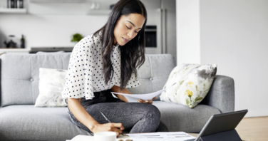 Woman analyzing documents while sitting at home-846