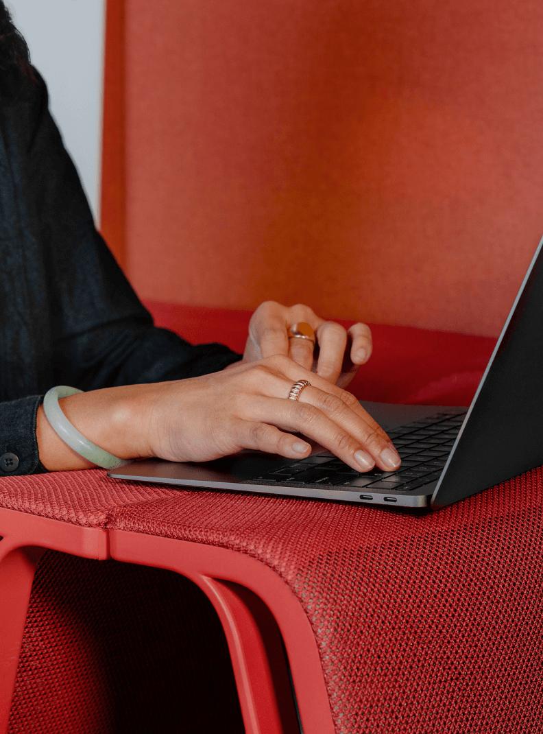 A set of hands typing on a laptop