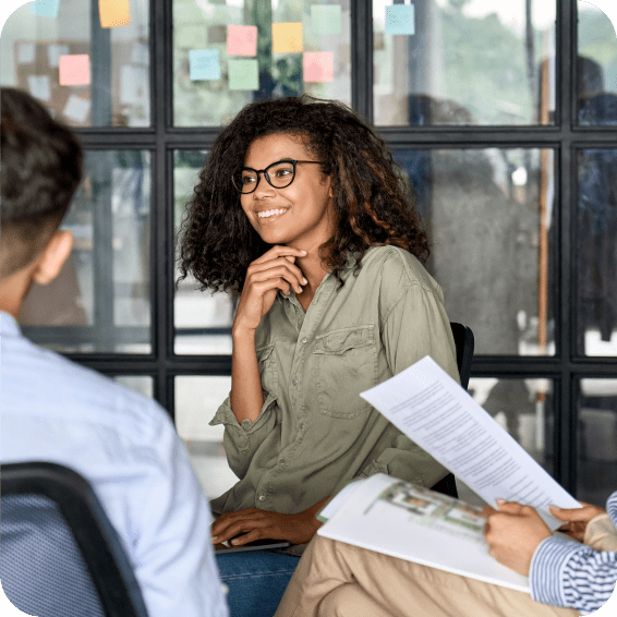 A lady listening to a colleague in a meeting