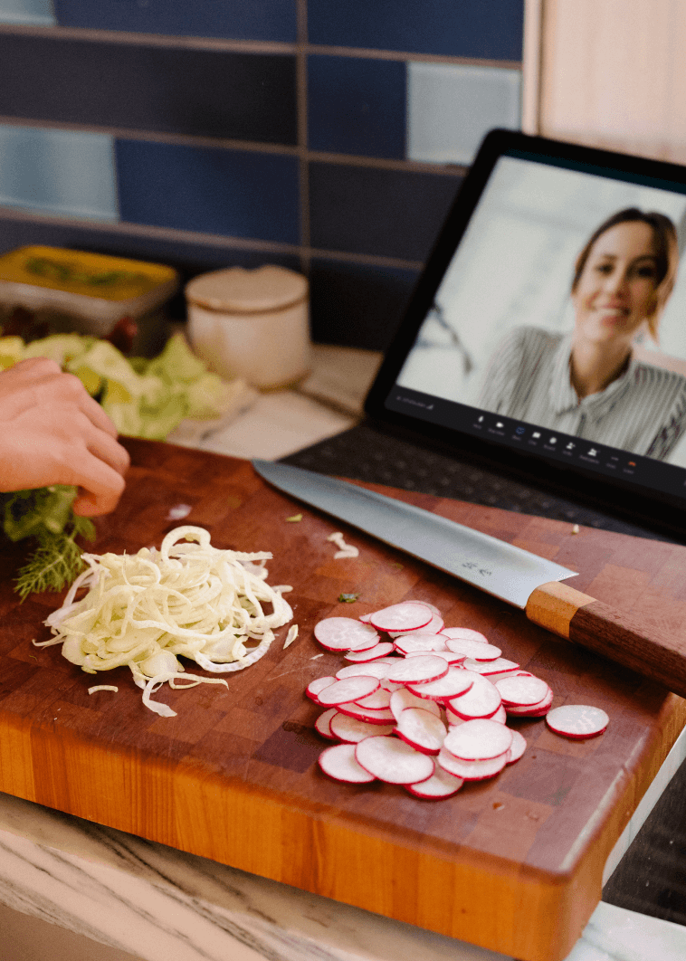 A person following instructions from a woman via a video call